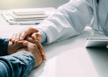 Hand of doctor reassuring patient. Partnership, trust and medic Hand of doctor reassuring patient. Partnership, trust and medical ethics concept.